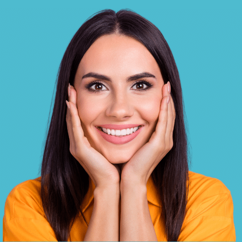 Smiling woman with dark hair resting chin on hand | Bright Orthodontics in Oshkosh, WI