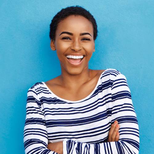Smiling woman wearing striped top outdoors | Bright Orthodontics in Oshkosh, WI