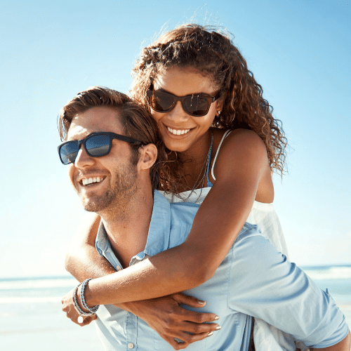 Smiling couple wearing sunglasses outdoors | Bright Orthodontics in Oshkosh, WI