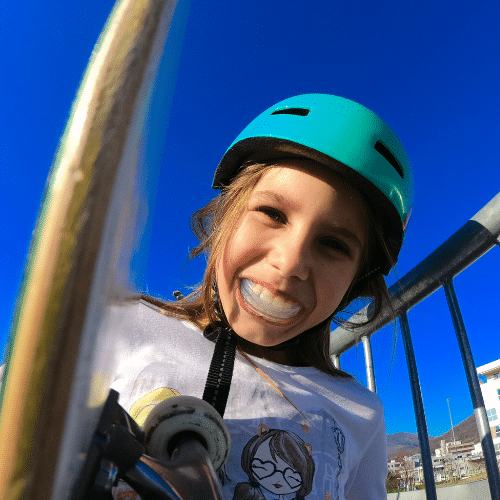 Young boy wearing green helmet looking up | Bright Orthodontics in Oshkosh, WI