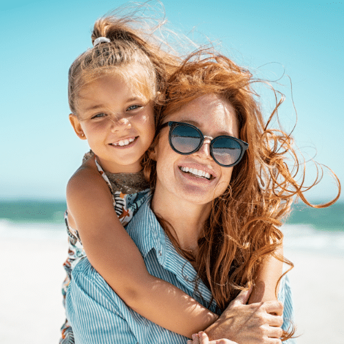 Smiling mother and daughter wearing sunglasses outdoors | Bright Orthodontics in Oshkosh, WI