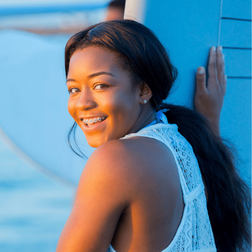 Smiling woman with curly hair outdoors | Bright Orthodontics in Oshkosh, WI