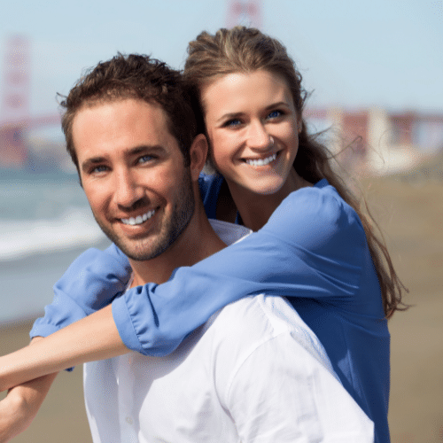 Smiling couple standing together outdoors | Bright Orthodontics in Oshkosh, WI