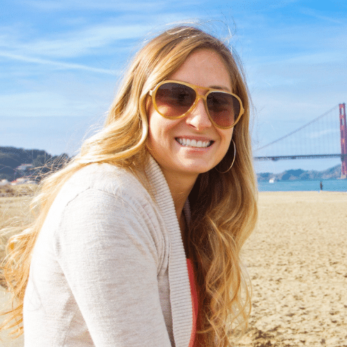 Smiling woman wearing sunglasses on beach | Bright Orthodontics in Oshkosh, WI