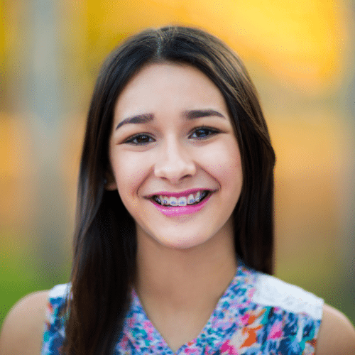 Smiling young woman with dark hair outdoors | Bright Orthodontics in Oshkosh, WI