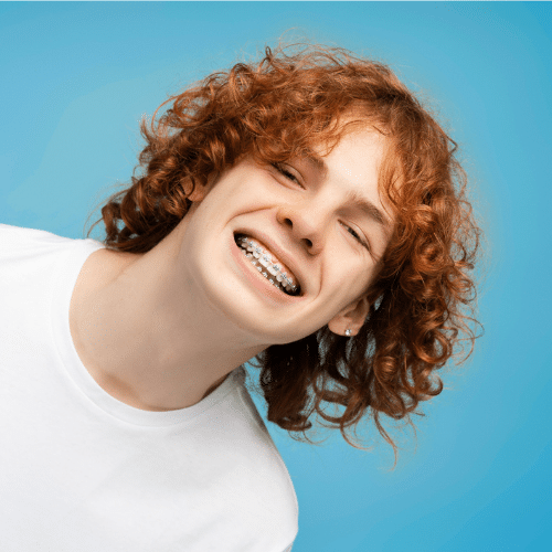 Smiling teen girl with curly red hair | Bright Orthodontics in Oshkosh, WI